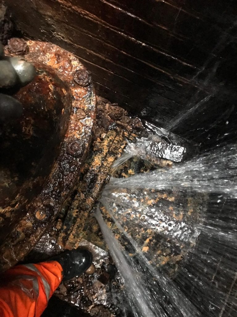 A burst underground carbon steel water main which had been leaking for 15 years