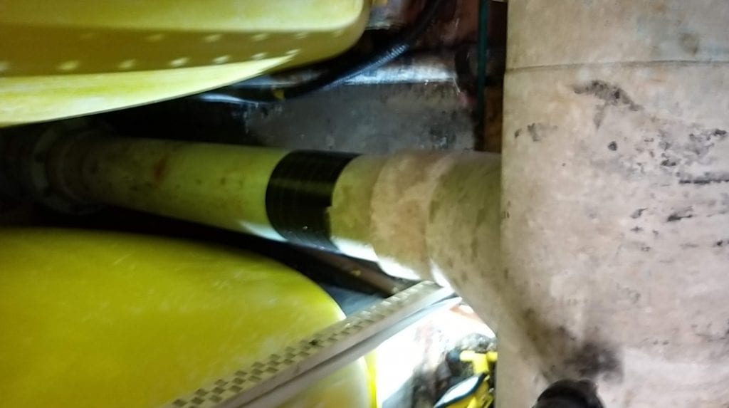 Wrap & Seal Waterproof Pipe Repair Tape used to seal a crack in a PVC plastic pipe in a swimming pool filtration system